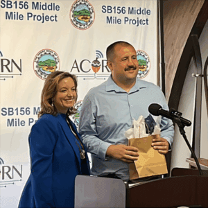 California Department of Technology (CDT)’s Chief Information Officer / Director Liana Bailey-Crimmins presents a gift to Hoopa Valley Tribal Chairman Joe Davis at the Hoopa Valley Tribe groundbreaking on August 12, 2025.